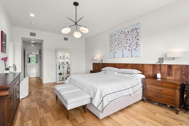 5728 Misty Hill Cv, Austin, TX 78759 - bedroom featuring light wood finished floors and a chandelier