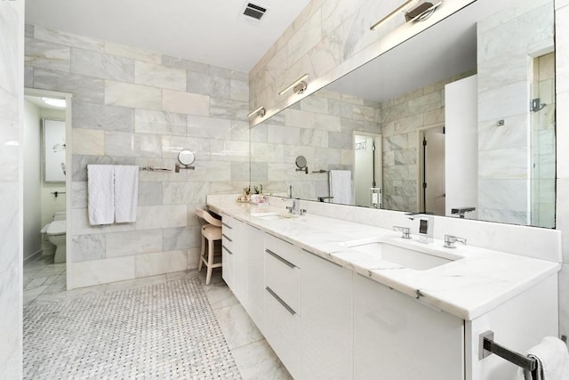 5728 Misty Hill Cv, Austin, TX 78759 - full bathroom featuring tile walls, double vanity, and toilet