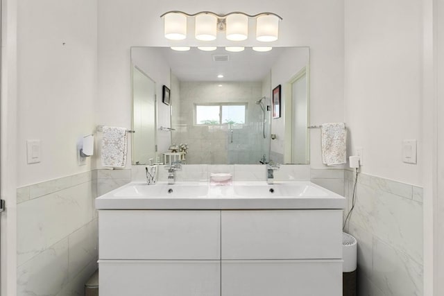 5728 Misty Hill Cv, Austin, TX 78759 - full bath featuring tile walls, a stall shower, a wainscoted wall, and double vanity