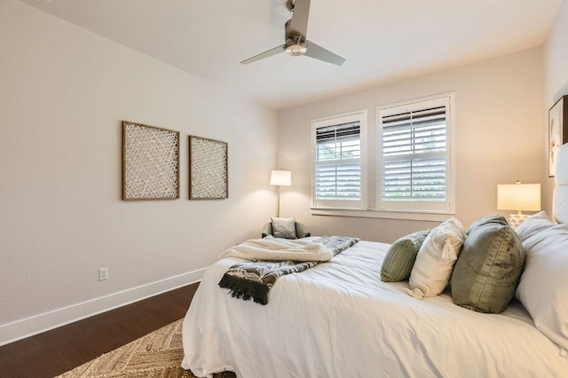 bedroom featuring baseboards, dark wood-type flooring, and ceiling fan