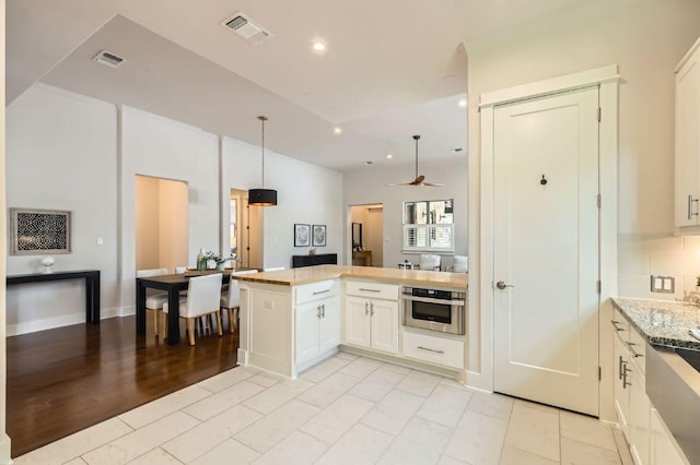kitchen featuring stainless steel oven, white cabinets, a peninsula, recessed lighting, and ceiling fan