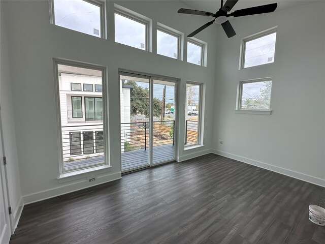 2111 Prather Ln Unit 1, Austin, TX 78704 - unfurnished room with a towering ceiling, dark wood-type flooring, baseboards, and ceiling fan
