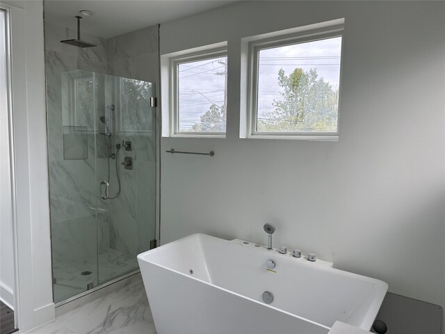 2111 Prather Ln Unit 1, Austin, TX 78704 - bathroom featuring a marble finish shower, marble look tiles, and a soaking tub