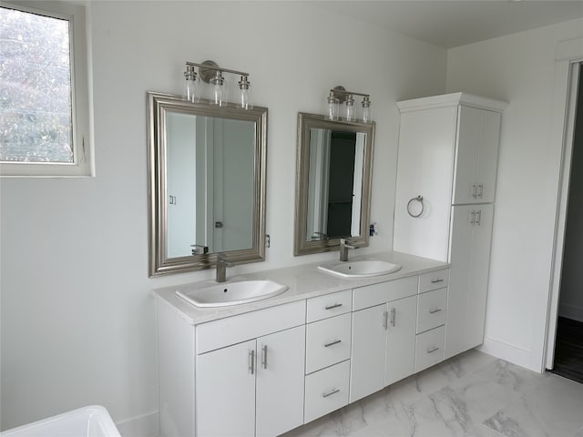 2111 Prather Ln Unit 1, Austin, TX 78704 - bathroom featuring marble look tile flooring, double vanity, and baseboards