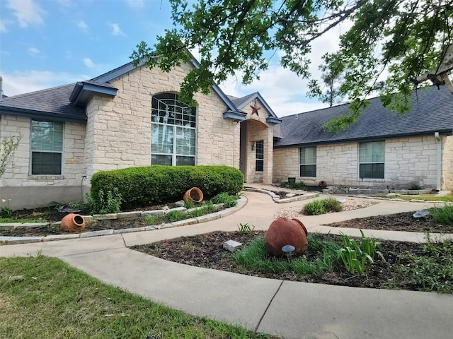 149 Mcallister Rd, Bastrop, TX 78602 - french country home featuring stone siding and roof with shingles