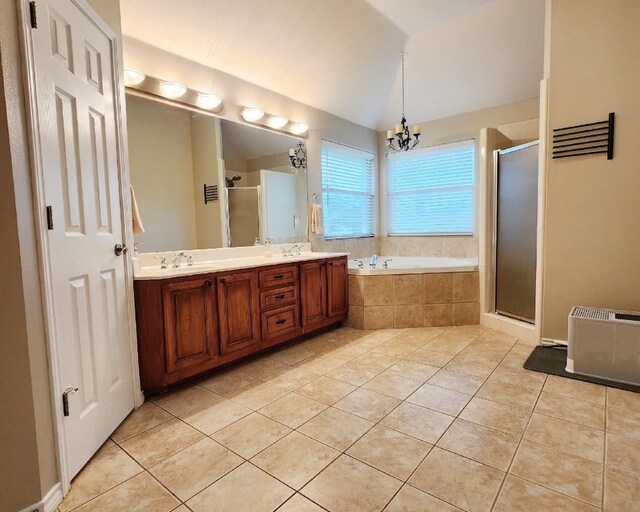 149 Mcallister Rd, Bastrop, TX 78602 - bathroom featuring tile patterned floors, a shower stall, a bath, a chandelier, and double vanity