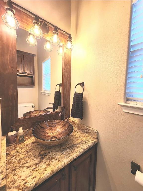 149 Mcallister Rd, Bastrop, TX 78602 - half bathroom featuring vanity and toilet