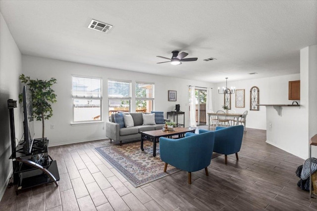 6820 Derby Downs Dr, Austin, TX 78747 - living area featuring ceiling fan, a chandelier, dark wood-style flooring, baseboards, and a textured ceiling