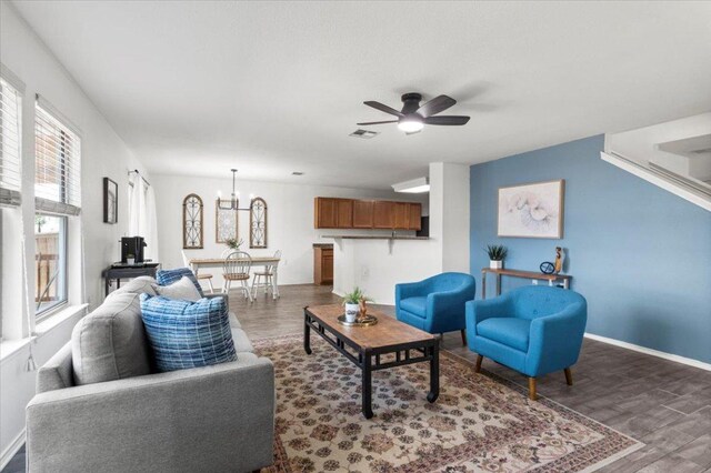6820 Derby Downs Dr, Austin, TX 78747 - living room with wood finished floors, a chandelier, and ceiling fan