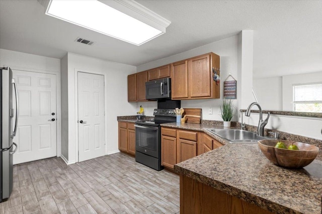 6820 Derby Downs Dr, Austin, TX 78747 - kitchen featuring stainless steel appliances, a sink, dark countertops, and brown cabinetry