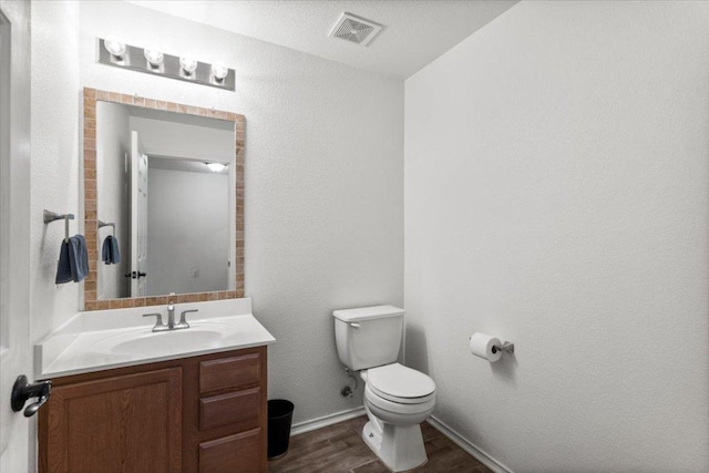 6820 Derby Downs Dr, Austin, TX 78747 - bathroom with wood finished floors, toilet, vanity, and baseboards