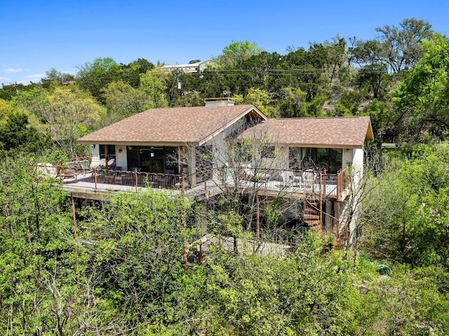 909 Redbud Trl, West Lake Hills, TX 78746 - back of house featuring a deck, a forest view, and roof with shingles