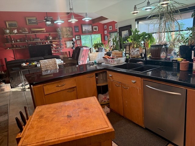 909 Redbud Trl, West Lake Hills, TX 78746 - kitchen with stainless steel dishwasher, a ceiling fan, brown cabinetry, a sink, and decorative light fixtures