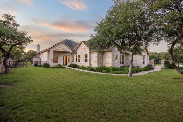 2761 Fishing Hole Cv, Leander, TX 78641 - french country home featuring stone siding, roof mounted solar panels, and a chimney