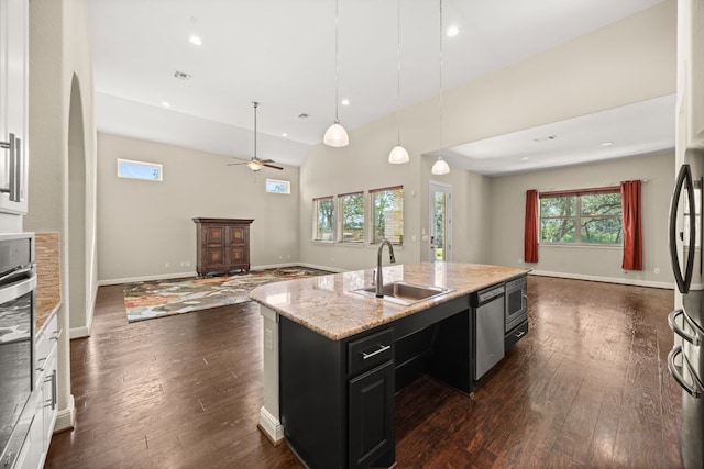 2761 Fishing Hole Cv, Leander, TX 78641 - kitchen with open floor plan, dark cabinetry, dark wood-style floors, recessed lighting, and lofted ceiling