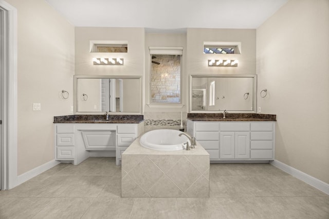 2761 Fishing Hole Cv, Leander, TX 78641 - full bath featuring a bath, two vanities, and tile patterned flooring