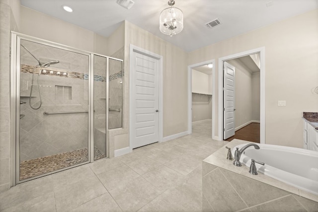 2761 Fishing Hole Cv, Leander, TX 78641 - full bath featuring a shower stall, a garden tub, vanity, a chandelier, and tile patterned floors