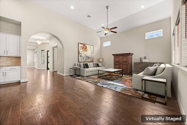 2761 Fishing Hole Cv, Leander, TX 78641 - living area featuring arched walkways, ceiling fan, dark wood-style flooring, plenty of natural light, and high vaulted ceiling