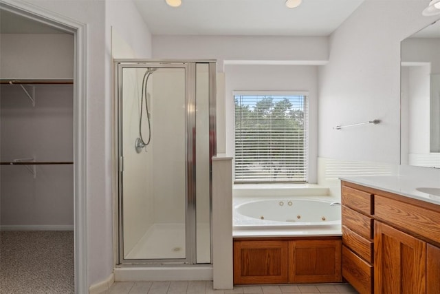 920 Barton Creek Dr, Dripping Springs, TX 78620 - bathroom featuring a shower stall, vanity, a spacious closet, a whirlpool tub, and recessed lighting