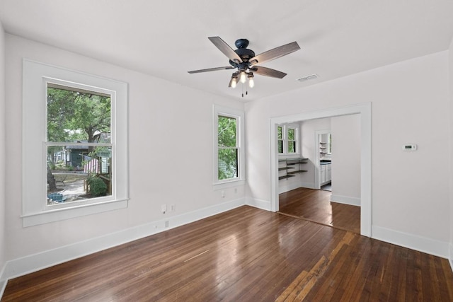 713 Patterson Ave, Austin, TX 78703 - unfurnished room with plenty of natural light, dark wood-style flooring, and baseboards