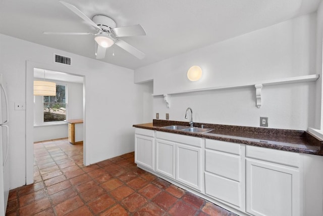 713 Patterson Ave, Austin, TX 78703 - kitchen featuring dark countertops, ceiling fan, white cabinetry, and open shelves