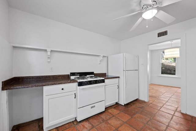 713 Patterson Ave, Austin, TX 78703 - kitchen featuring white appliances, dark countertops, open shelves, and white cabinets