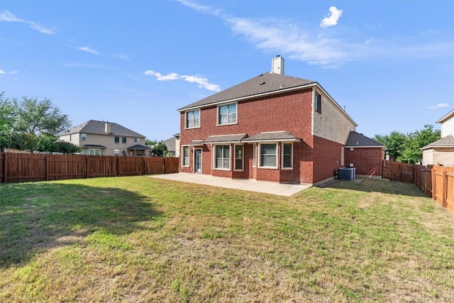 rear view of property with a patio, brick siding, central air condition unit, and a chimney