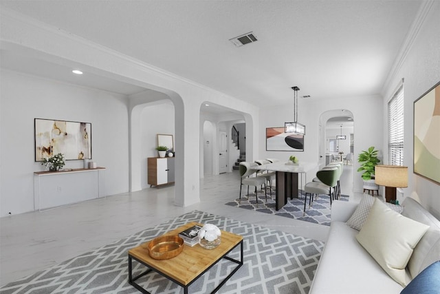 living area with arched walkways, crown molding, and recessed lighting