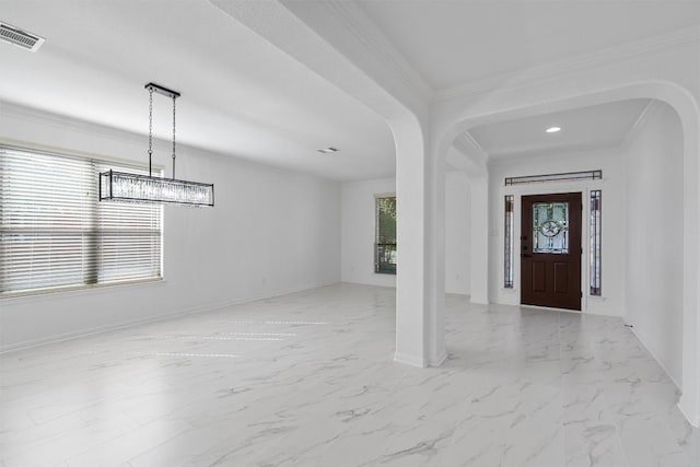 foyer featuring arched walkways, light marble finish floors, baseboards, and ornamental molding