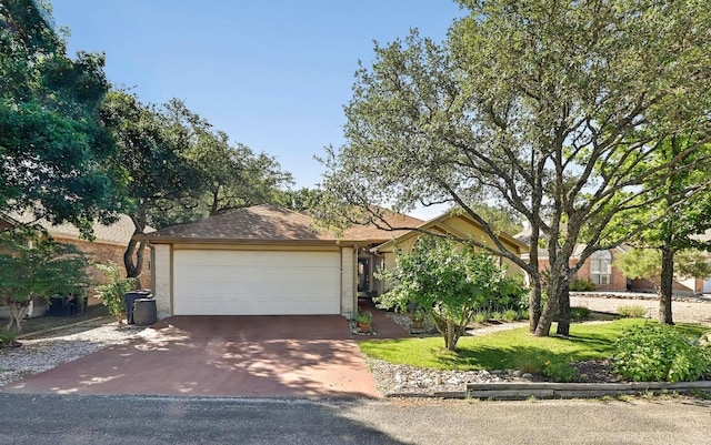 217 Fox Xing, Burnet, TX 78611 - obstructed view of property with asphalt driveway, a garage, and a front lawn