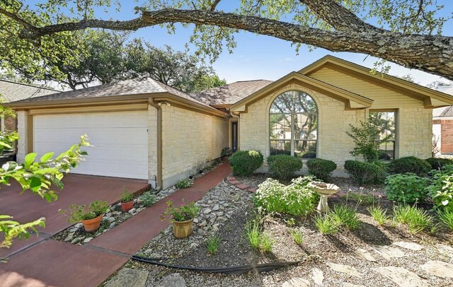 217 Fox Xing, Burnet, TX 78611 - single story home with stone siding, a garage, roof with shingles, and concrete driveway