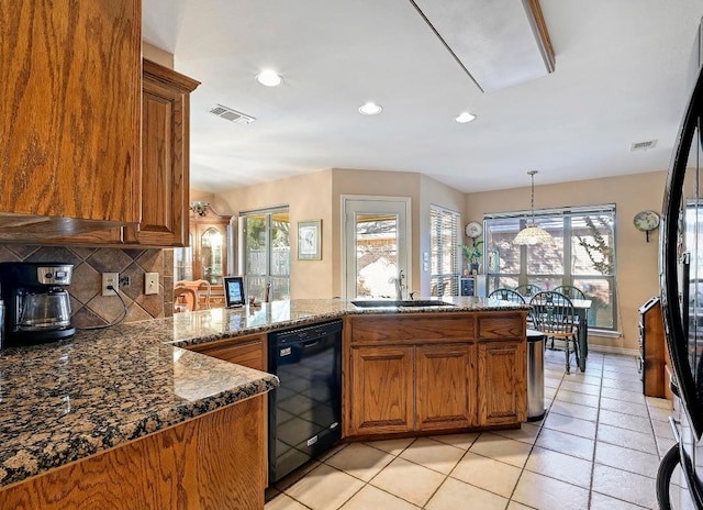 217 Fox Xing, Burnet, TX 78611 - kitchen with black appliances, a sink, brown cabinetry, plenty of natural light, and recessed lighting