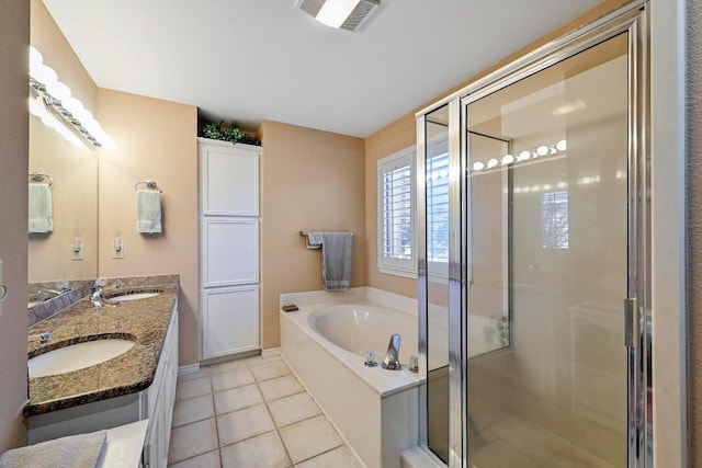 217 Fox Xing, Burnet, TX 78611 - full bathroom featuring a bath, a stall shower, tile patterned floors, and double vanity