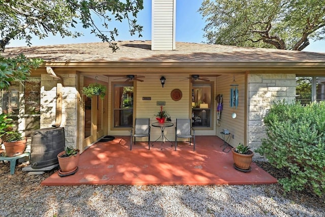 217 Fox Xing, Burnet, TX 78611 - back of house featuring a ceiling fan, a chimney, and roof with shingles