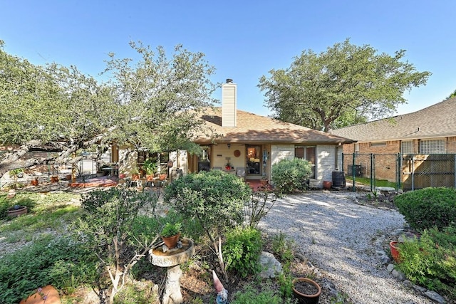 217 Fox Xing, Burnet, TX 78611 - rear view of house with fence, a chimney, and cooling unit
