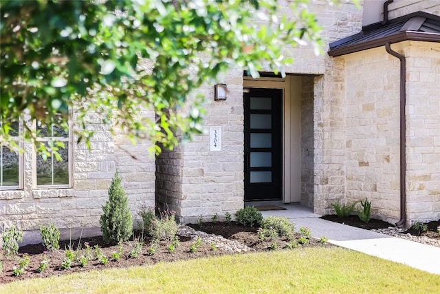 view of exterior entry featuring stone siding