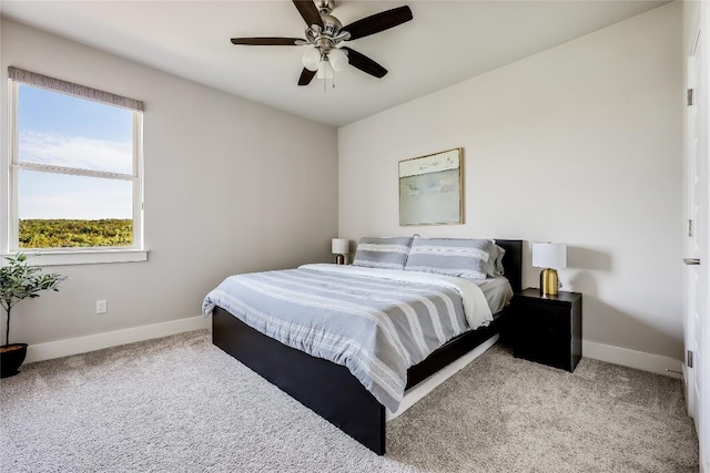 carpeted bedroom with baseboards and ceiling fan