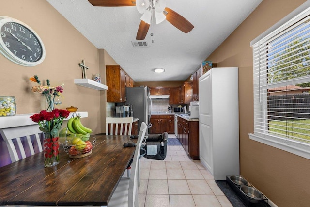 1611 Velma Ave, Copperas Cove, TX 76522 - kitchen with light tile patterned flooring, light countertops, a ceiling fan, stainless steel appliances, and lofted ceiling