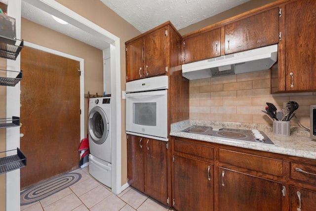 1611 Velma Ave, Copperas Cove, TX 76522 - kitchen featuring white oven, under cabinet range hood, electric stovetop, backsplash, and light countertops