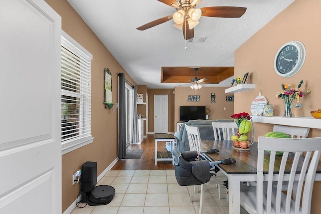 1611 Velma Ave, Copperas Cove, TX 76522 - dining area with ceiling fan, light tile patterned flooring, baseboards, and a raised ceiling