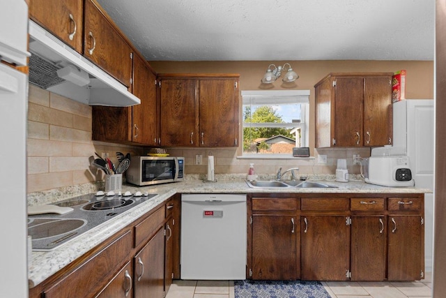 1611 Velma Ave, Copperas Cove, TX 76522 - kitchen featuring white dishwasher, a sink, stainless steel microwave, under cabinet range hood, and light countertops