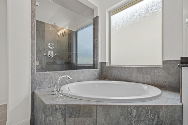 full bath featuring a garden tub and plenty of natural light