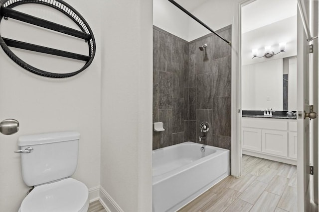 full bath with toilet, shower / washtub combination, vanity, and baseboards