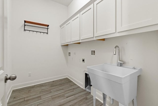 laundry room featuring cabinet space, washer hookup, hookup for an electric dryer, light wood-style floors, and baseboards