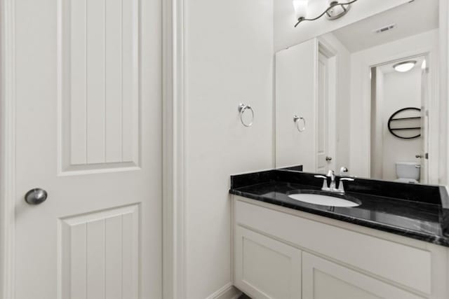 bathroom with vanity and toilet