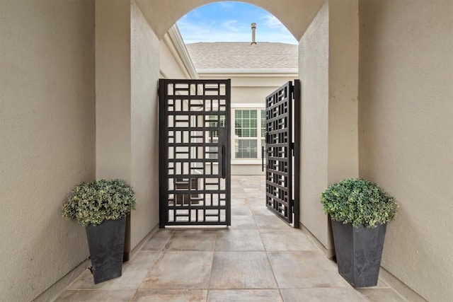 entrance to property featuring stucco siding