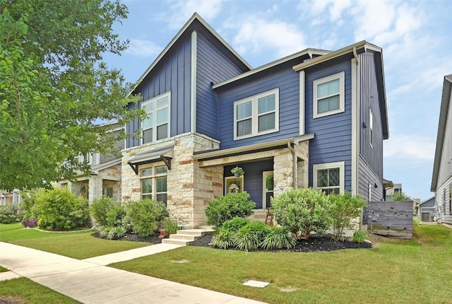 8716 Mina Dr, Austin, TX 78747 - contemporary house with stone siding, board and batten siding, and a front lawn