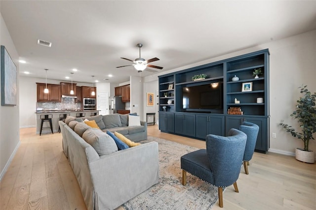 8716 Mina Dr, Austin, TX 78747 - living area featuring light wood finished floors, a ceiling fan, and recessed lighting