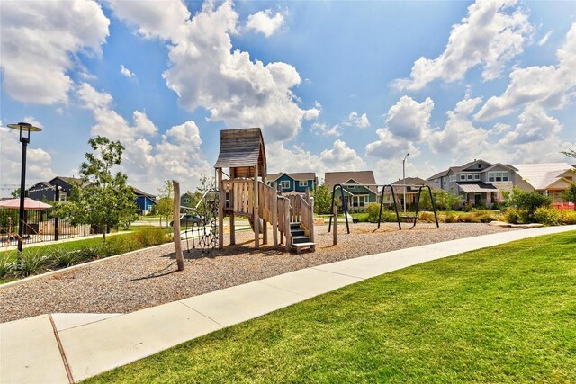 8716 Mina Dr, Austin, TX 78747 - community play area featuring a residential view and a lawn