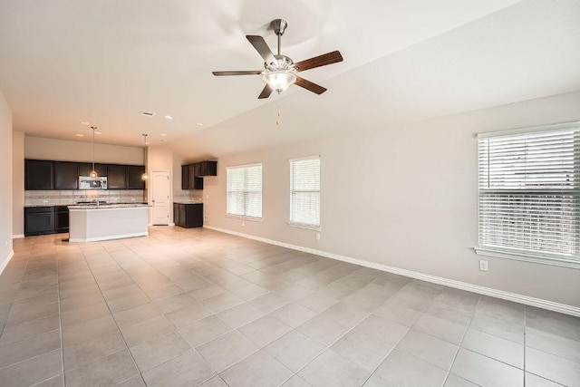 20020 Rhiannon Ln, Pflugerville, TX 78660 - unfurnished living room featuring a ceiling fan, lofted ceiling, and light tile patterned floors